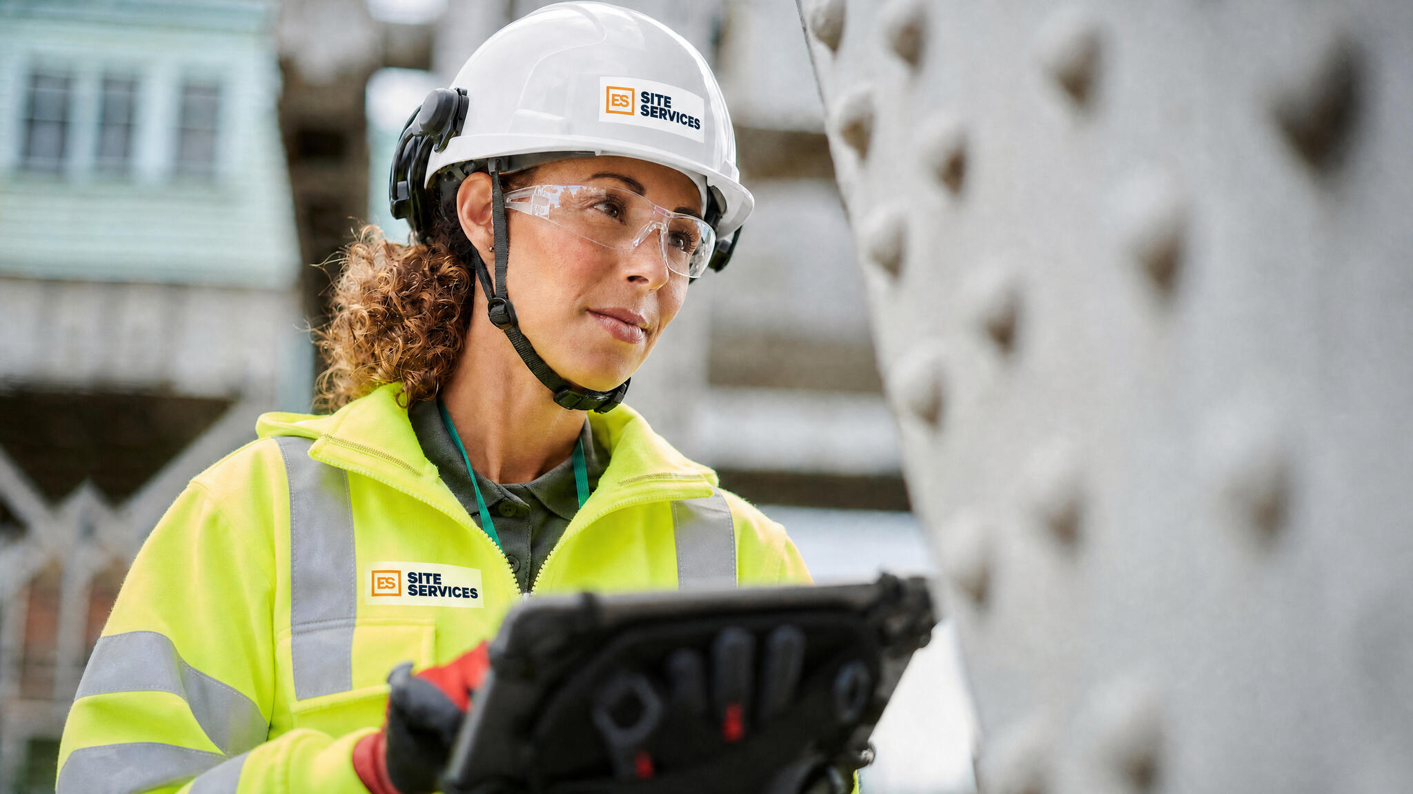 Woman with LCD tablet in PPE gear